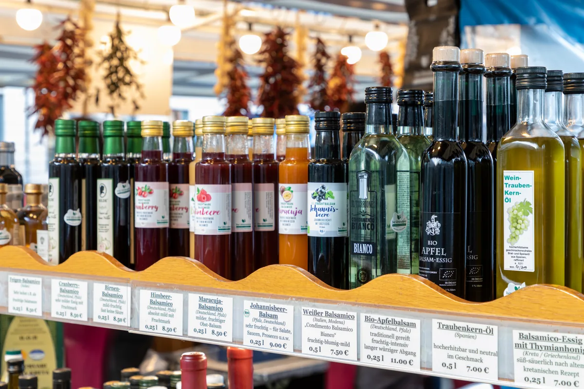 Bottles of vegetable oils and vinegars for sale at a weekly market in Münster, Germany