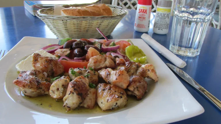 Plate of grilled chicken souvlaki made with a Greek lemon and oregano marinade, with olives