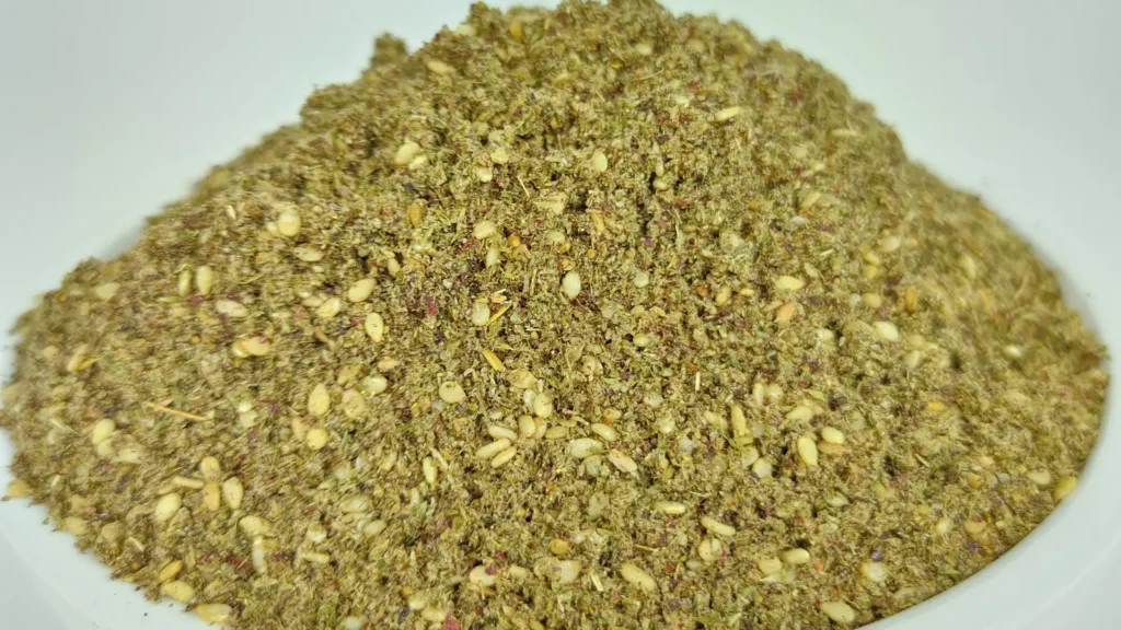 Close-up of a mound of za’atar, a blend of dried Origanum syriacum, sumac, sesame seeds and salt