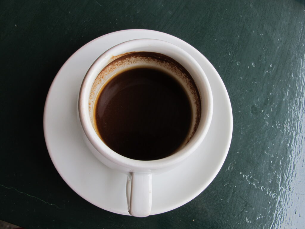 A small cup of Greek coffee on a saucer