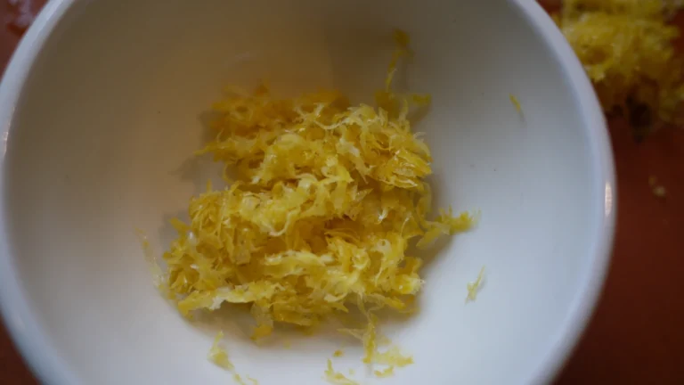 Freshly grated lemon zest in a small white bowl
