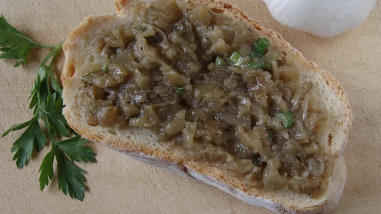 Melitzanosalata, Greek roasted eggplant salad, spread on a slice of bread with parsley