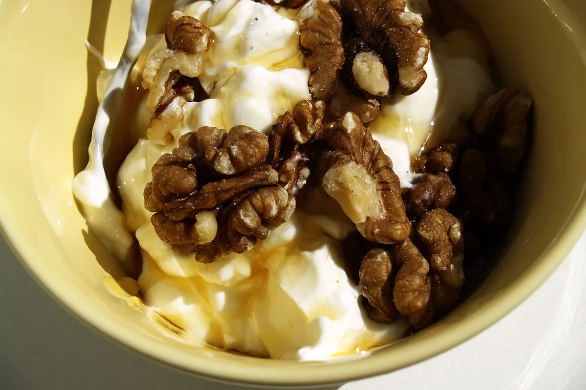 Bowl of Greek yogurt with honey and walnuts