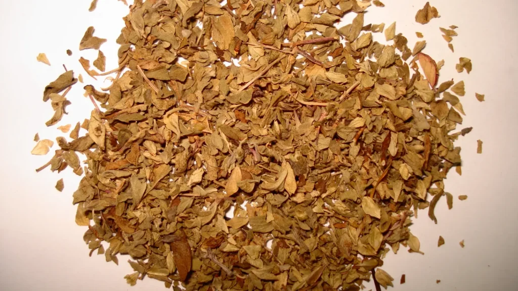 A heap of crumbled dried oregano leaves, the herb you need a substitute for