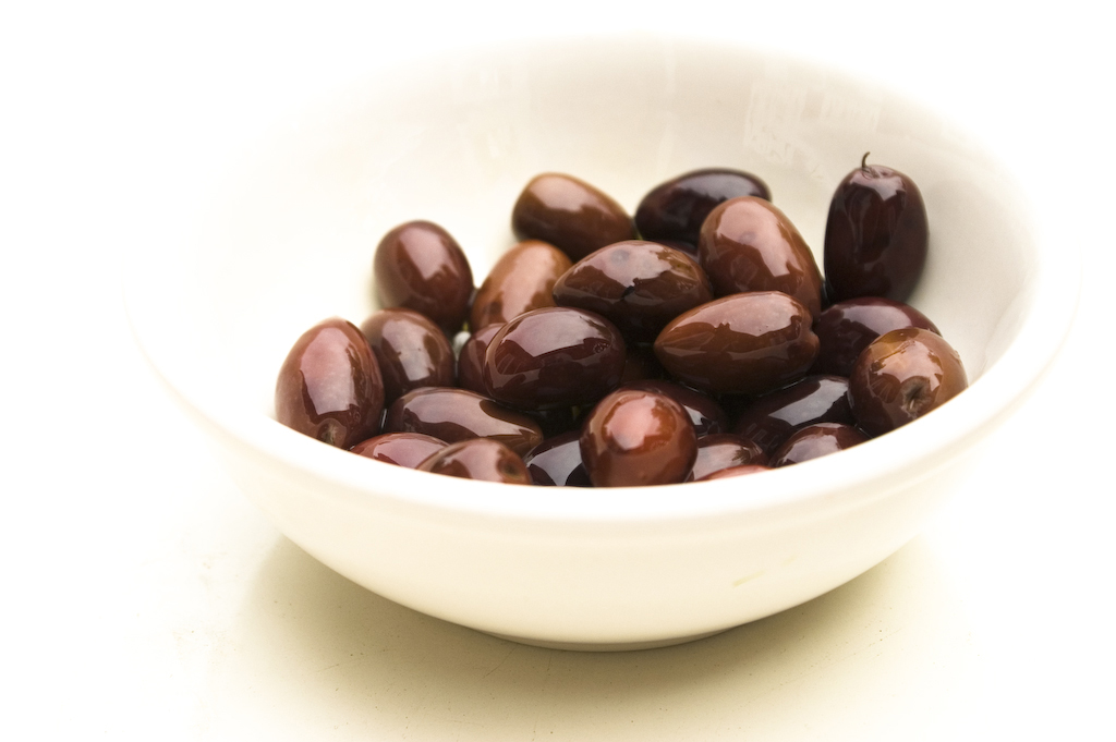 Dark Kalamata olives in a white bowl