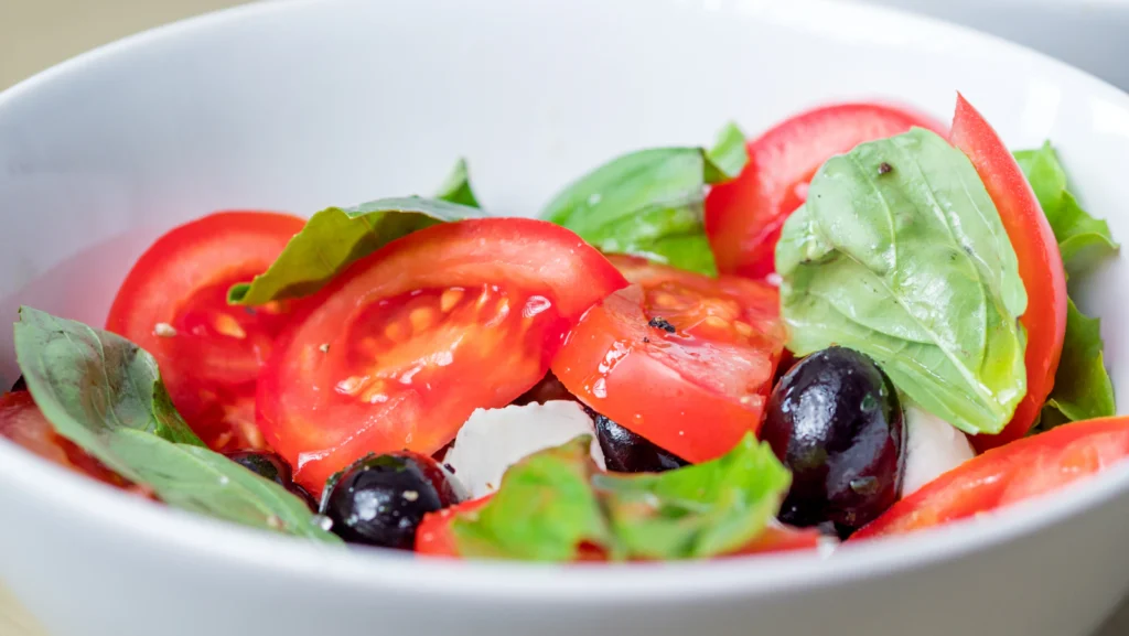 Tomato, olive and mozzarella salad, illustrative serving suggestion