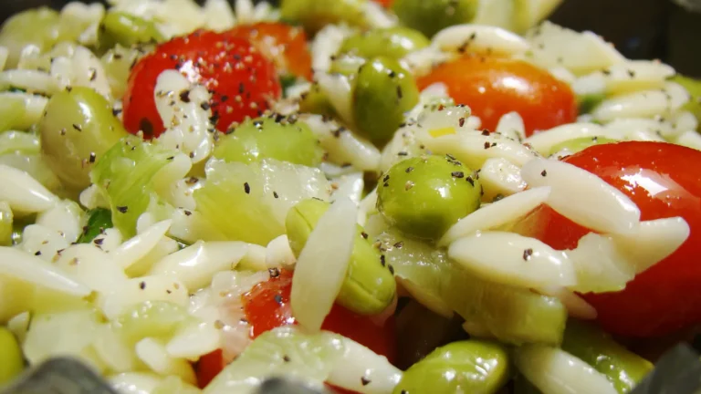 An orzo pasta salad with cherry tomatoes, edamame and herbs
