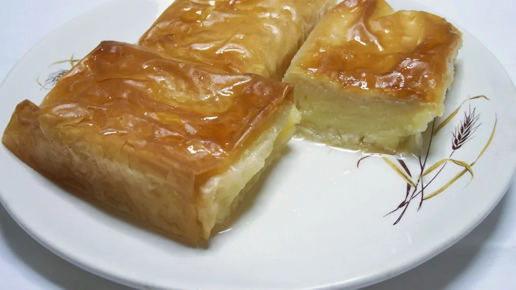 Three pieces of galaktoboureko, Greek semolina custard baked in phyllo and soaked in syrup