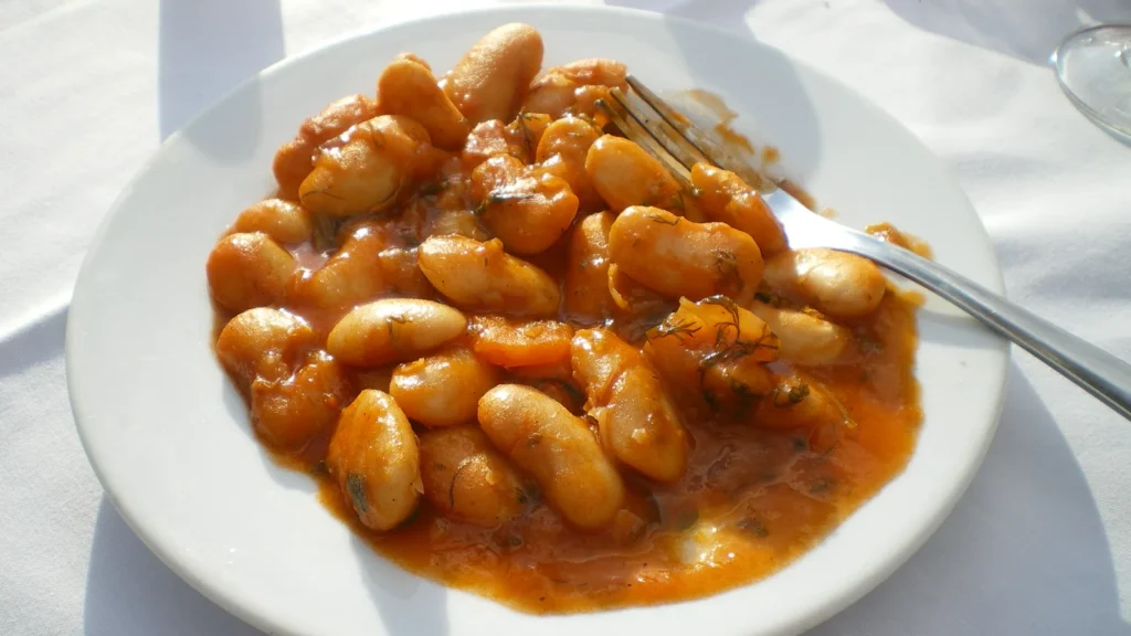 A plate of gigantes plaki, Greek giant beans baked in tomato sauce