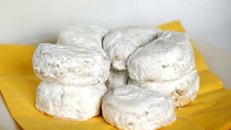 A platter of Greek kourabiedes butter cookies thickly coated in powdered sugar