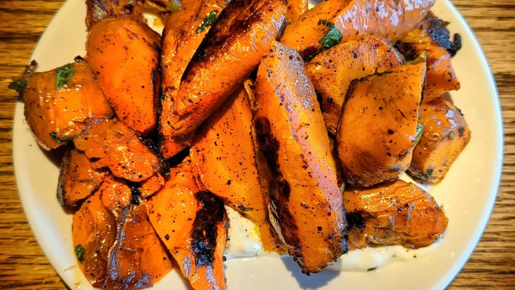 Caramelised roasted carrots piled on a plate