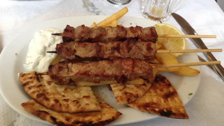 Grilled souvlaki skewers served with pita bread and tzatziki in Athens