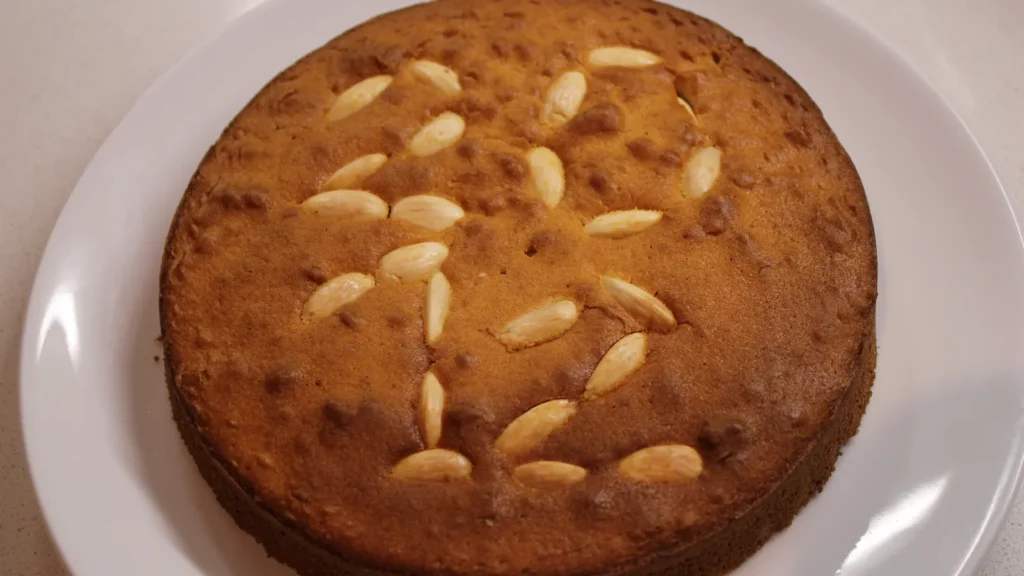 A round vasilopita, the Greek New Year cake, decorated with blanched almonds