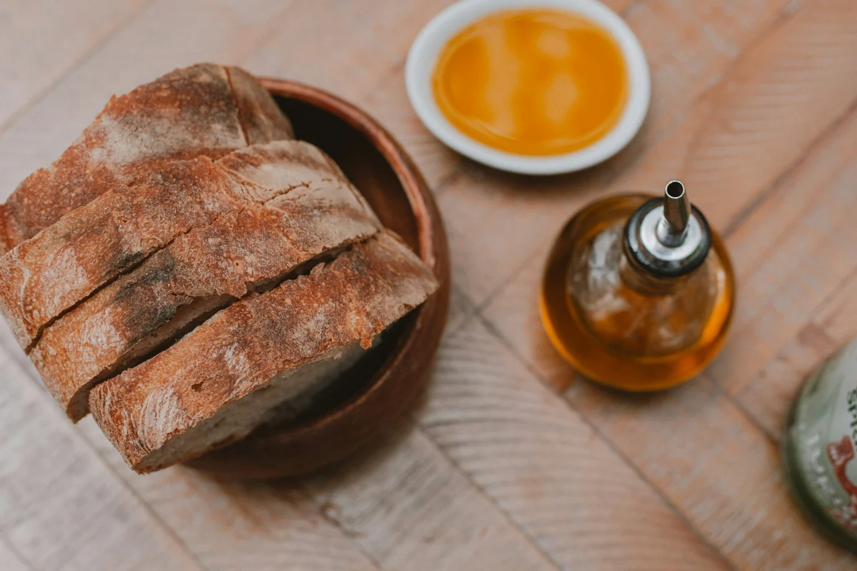Sliced bread with a small dish of olive oil for tasting