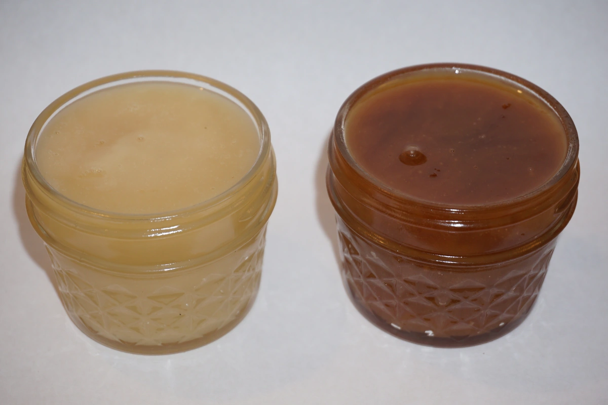 Two jars side by side comparing creamed honey vs liquid honey colour and texture
