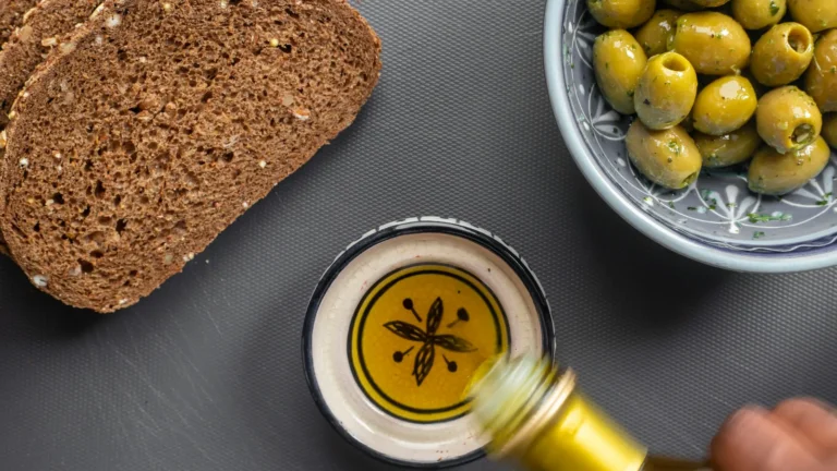 Bread, green olives and a dish of olive oil, simple Greek olive oil uses at the table