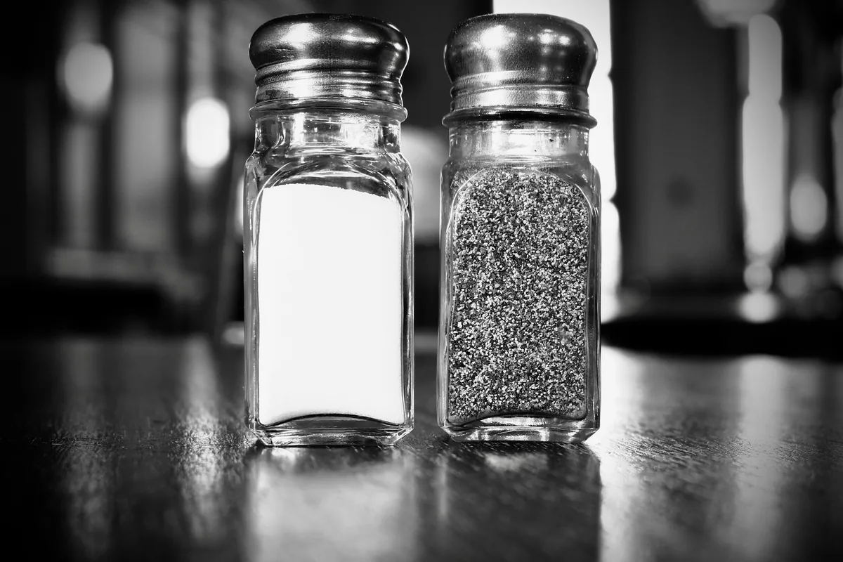 Salt and pepper shakers holding ground salt for everyday seasoning