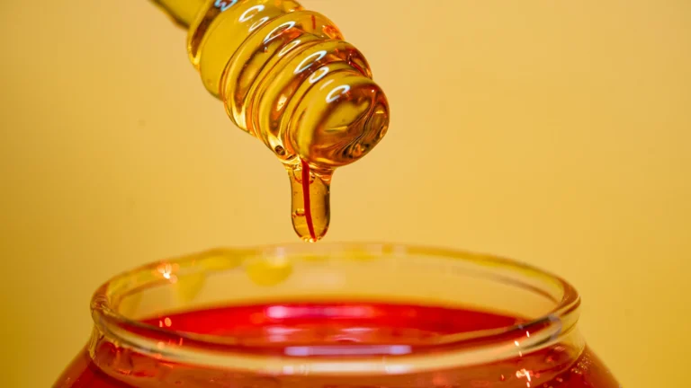 Liquid honey dripping into a jar, one side of creamed honey vs liquid honey
