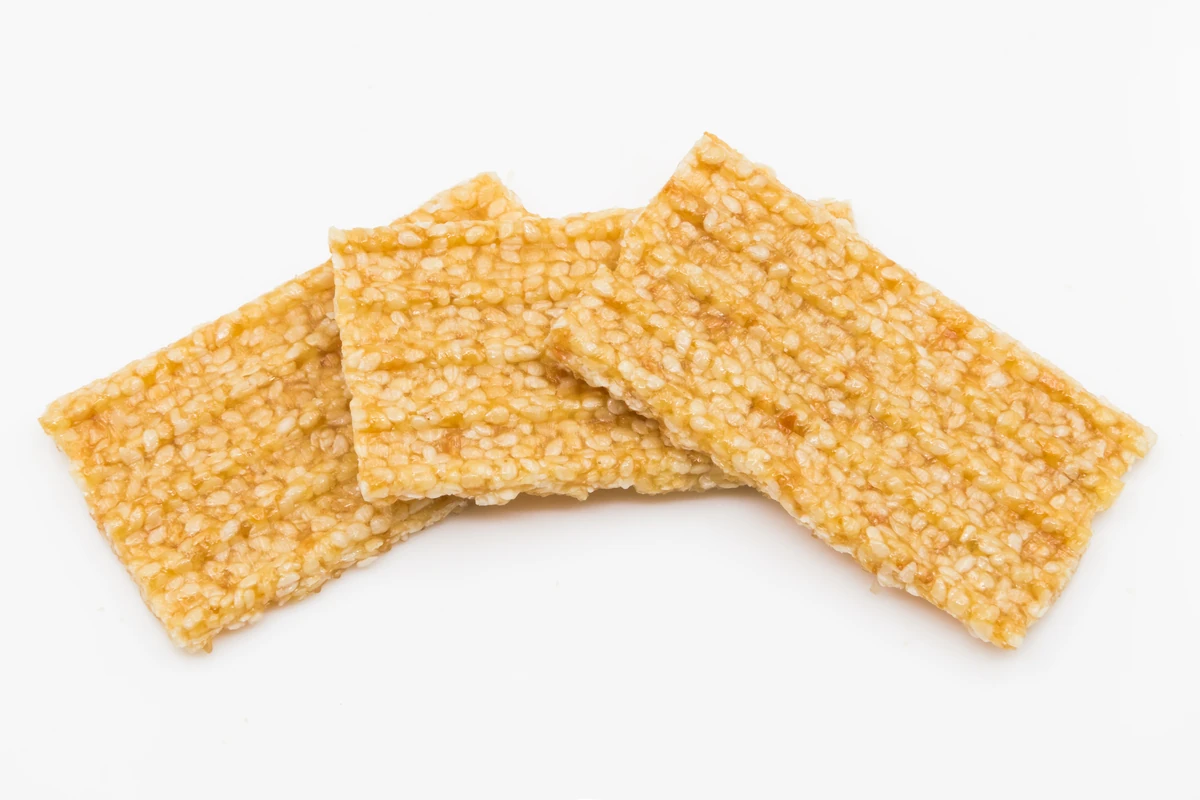 Three crisp sesame seed brittle bars on white