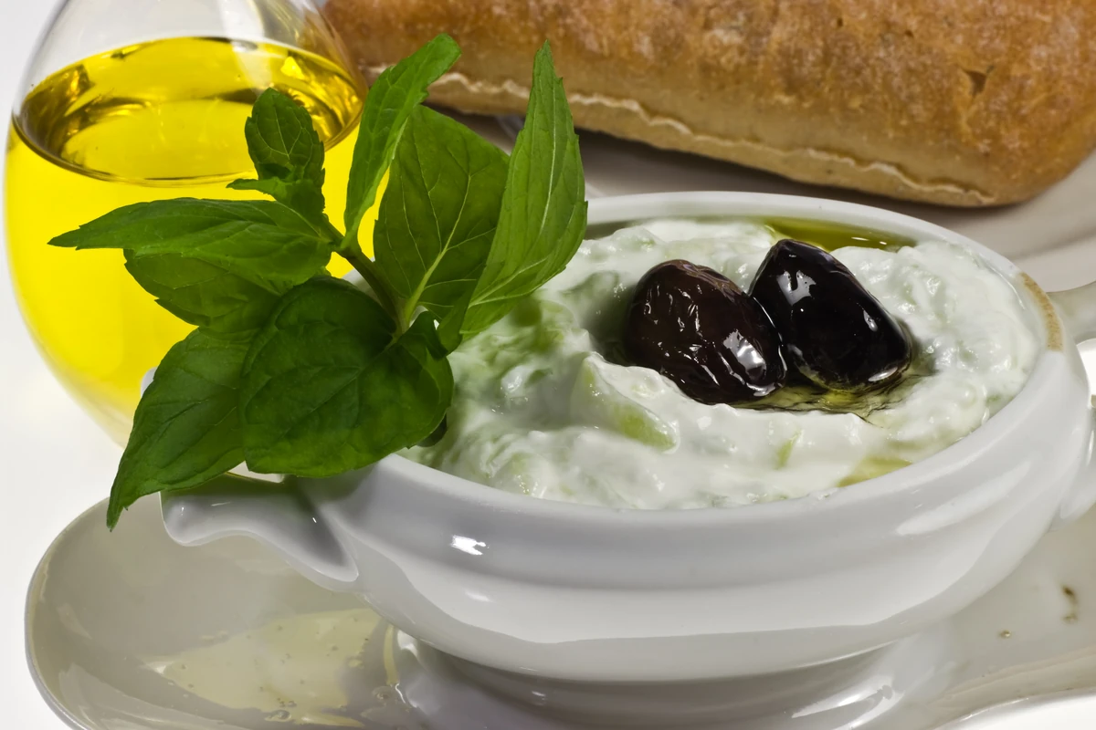 Tzatziki topped with olives and basil, a simple Greek pantry mezze dish